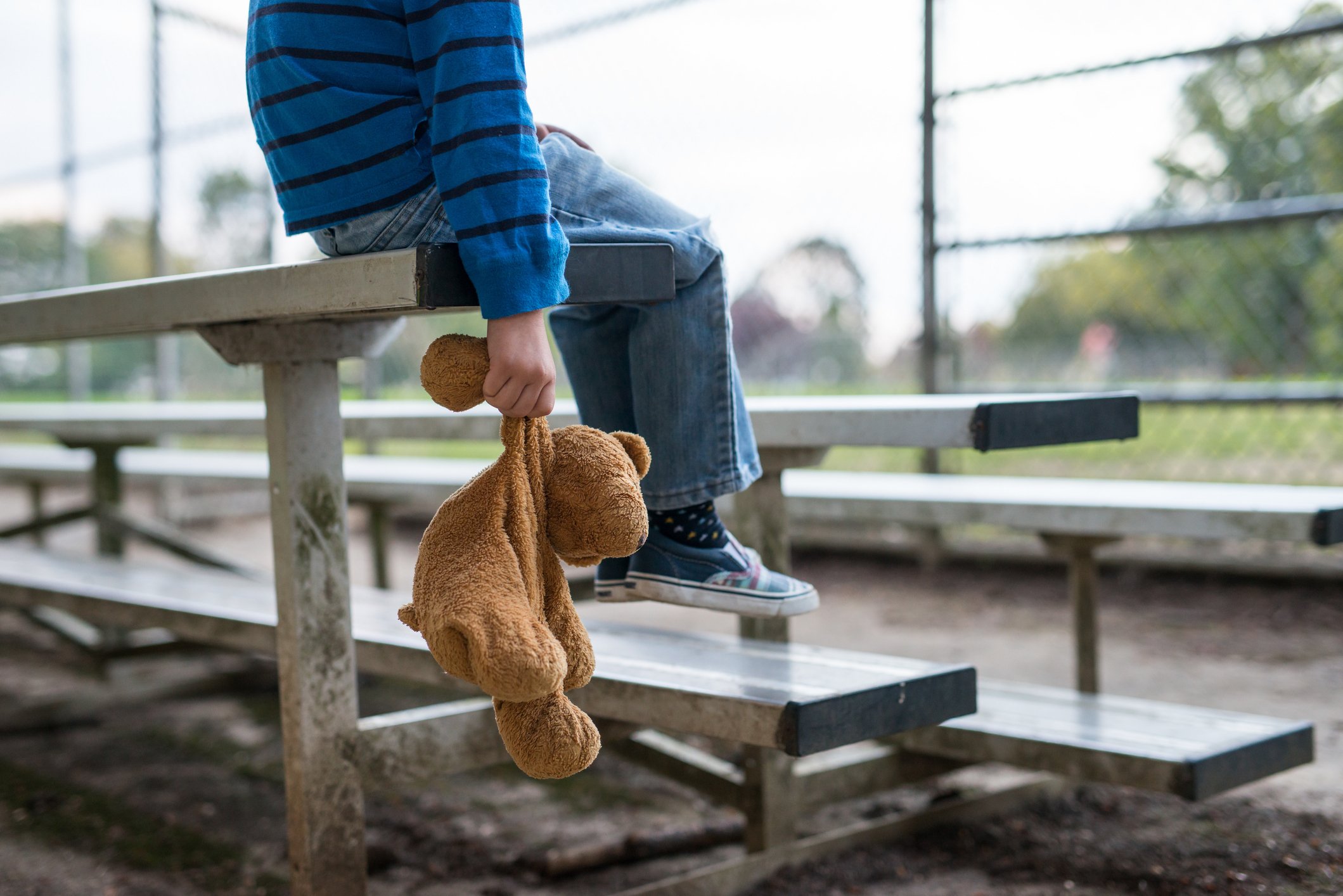 Child with teddy in a park