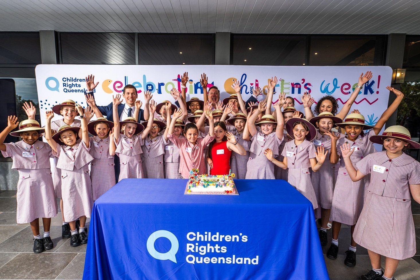 Students cutting the Children's Week cake